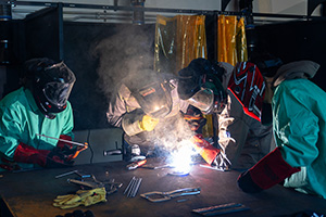 Workforce training center students practicing welding